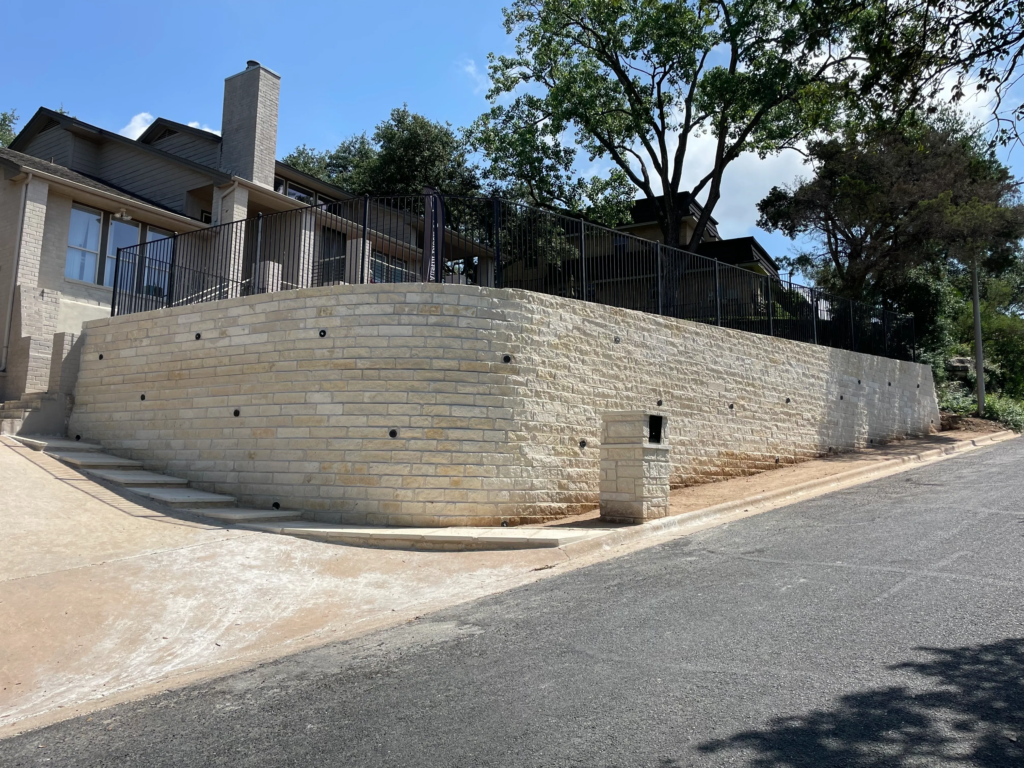 Westlake residential chopped stone retaining wall with walkway and stairs